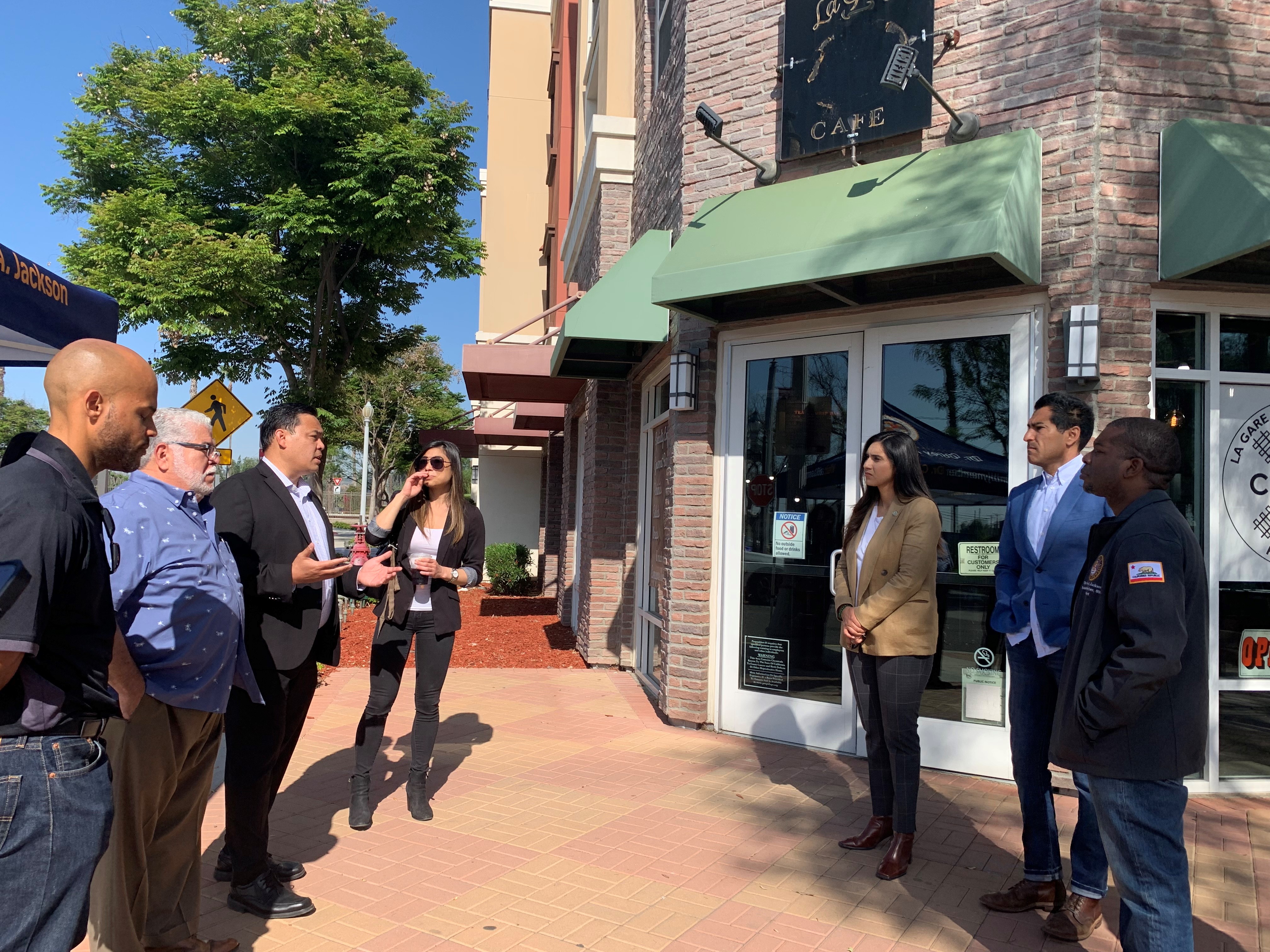 Tour in Downtown Perris with elected officials. In front of a coffee house.